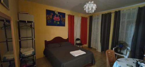 a bedroom with a bed and a chandelier at Studio Aiko2 côtière in Mauritius
