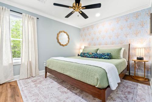 a bedroom with a bed and a ceiling fan at Roaring On Ross In Auburn in Auburn