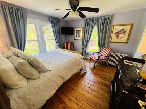 a bedroom with a bed and a ceiling fan at Beacon Hermitage in Beacon