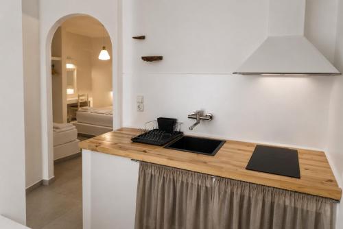 a kitchen with a sink and a counter top at Filoxenia Apartments in Adamantas