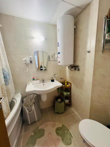 a bathroom with a sink and a toilet and a tub at Bansko Aspen Relax & Chill in Bansko