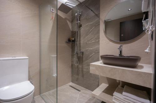 a bathroom with a toilet and a sink and a shower at Bazaar Inn Boutique & Luxury Rooms in Skopje