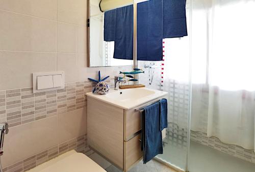 a bathroom with a sink and a shower at Appartamenti Alaska in Bibione