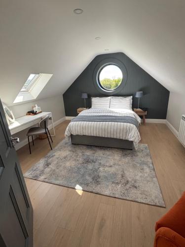 a bedroom with a bed and a window and a desk at Beyren House Guest Suite in Emo