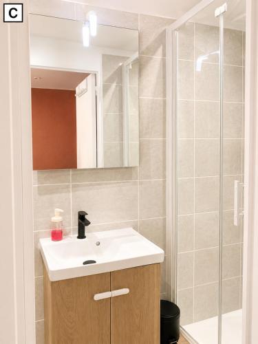 a bathroom with a sink and a shower at Notre Dame in Perpignan