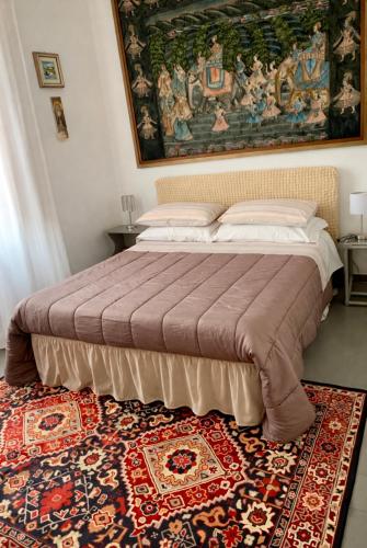 a bed in a bedroom with a rug on the floor at Guest House A Due Passi in Olbia