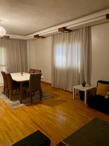 a living room with a table and chairs and a couch at Golden Rose- men only in 6th Of October