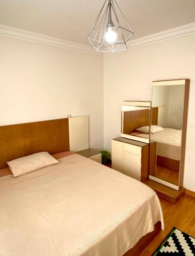 a bedroom with a large bed and a mirror at Golden Rose- men only in 6th Of October