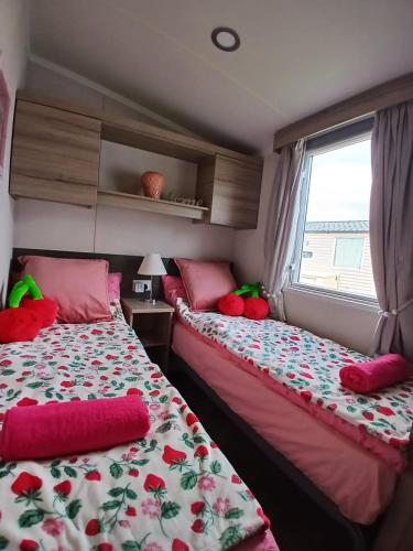 a bedroom with two beds and a window at 8 Moray View Seton Sands in Port Seton