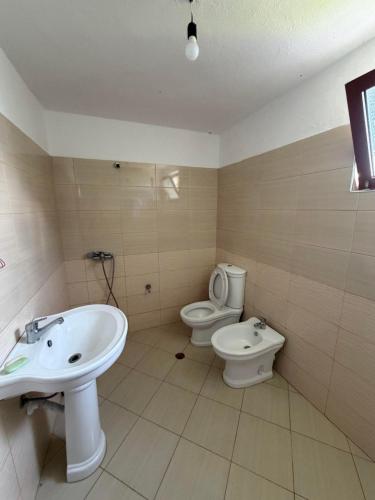 a bathroom with a sink and a toilet at Hasan Nika's Tower in Karicë