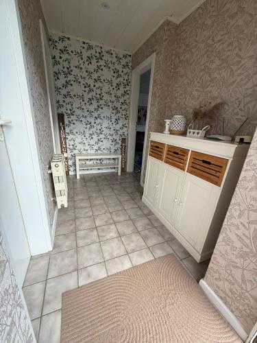 a kitchen with a table and a bench in a room at Nordwind Sjut in Warnow