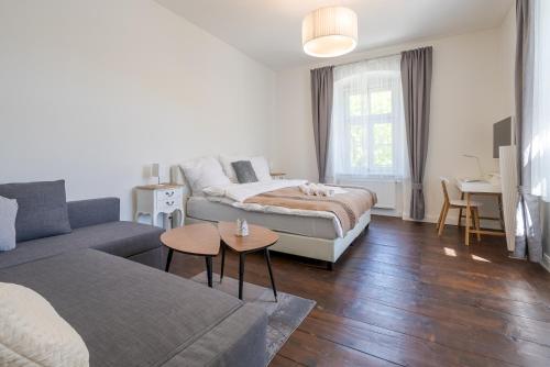 a living room with a bed and a couch at Alte Schule Reichenau an der Rax in Reichenau