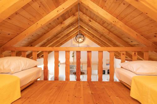 a room with two beds in a attic at Holiday Home Grubišić in Mirce