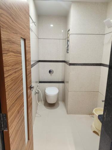 a small bathroom with a toilet and a sink at Hotel Decent in Bhāndu