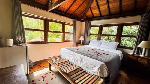 a bedroom with a bed with flowers on it at Pousada Papyrus in Tiradentes
