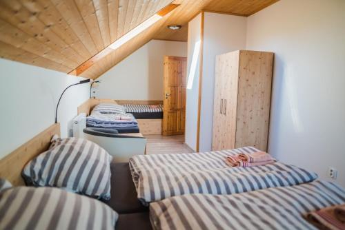 a room with two beds and a closet at Chalupa Rébus in Loučná nad Desnou