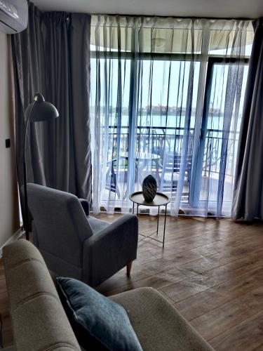 a living room with a couch and a table at DL Apartments in Aheloy