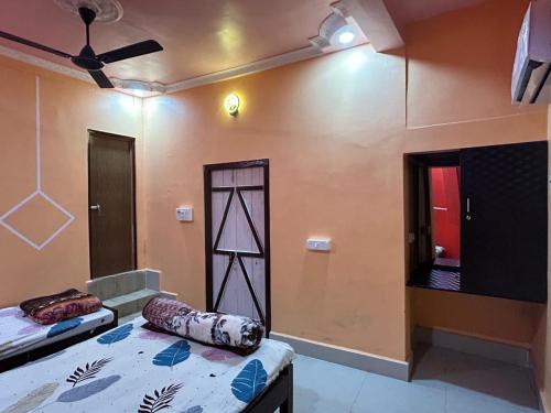 a room with two beds and a mirror in it at Snehalata Lodge in Badarpur