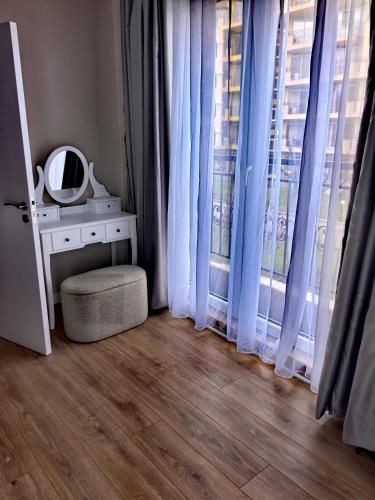 a room with a mirror on a table and a window at DL Apartments in Aheloy