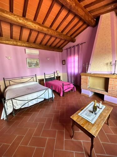 a large room with two beds and a table at B&B Pizziconi Relax in Podere Modello