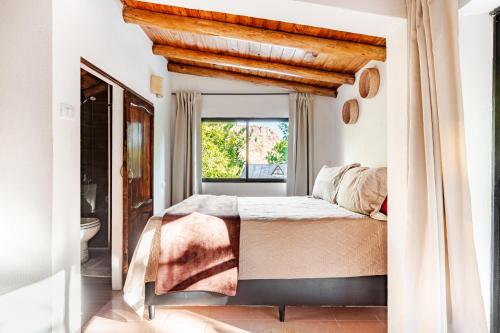 a bedroom with a large bed and a window at Complejo Ermitazh in Valle Grande