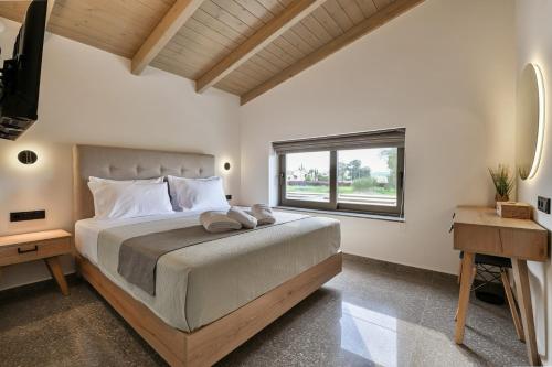 a bedroom with a large bed and a window at Vagg Villas in Preveza