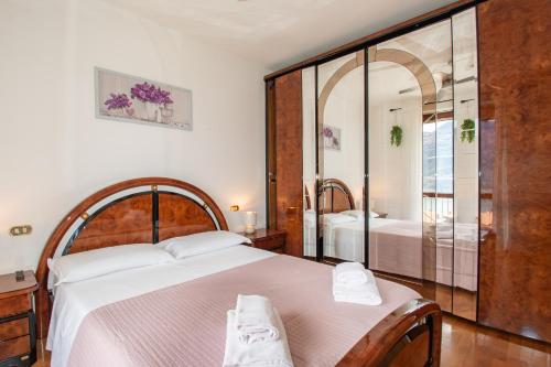 a bedroom with a large bed and a mirror at CASA di CRISTOF ISEO in Lovere