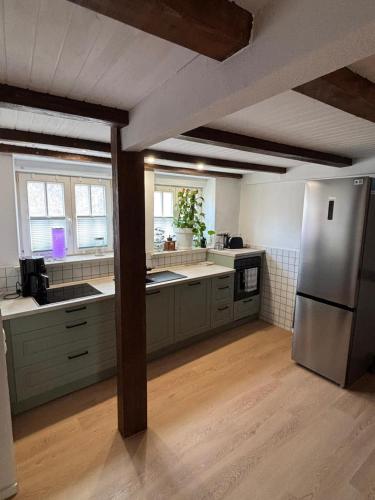 a kitchen with a stainless steel refrigerator and counters at Ferienhaus Wallkieker in Boizenburg