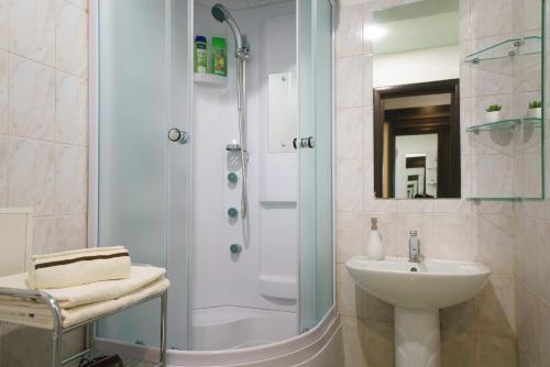 a bathroom with a shower and a sink and a toilet at PaulMarie Apartments on Boldina in Mogilev