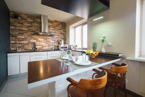 a kitchen with a table and some chairs in it at PaulMarie Apartments on Boldina in Mogilev