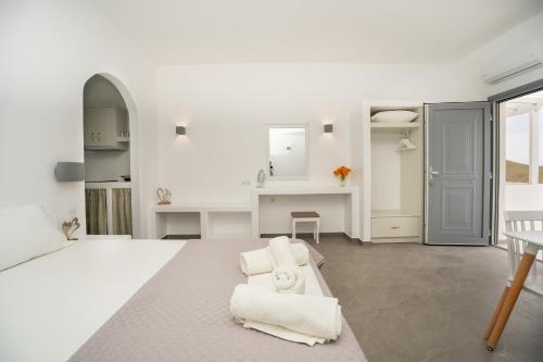 a white room with a white bed and a desk at Galaxy studios in Astypalaia