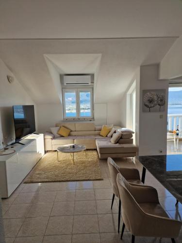 a living room with a couch and a table at Compass Apartment in Trogir