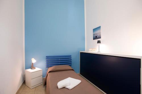 a bedroom with a bed and a large screen tv at Pozzallo yellow house,5'dal mare in Pozzallo