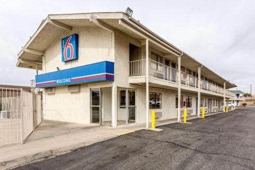 a hotel with a parking lot in front of it at Motel 6 Albuquerque Northeast in Albuquerque