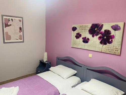 a bedroom with two beds and a painting on the wall at Villa Sofia in Chrani