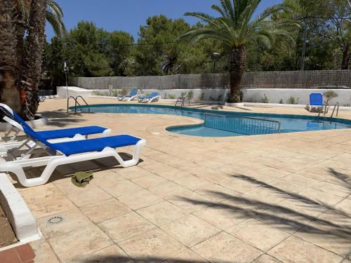 a pool with two lounge chairs and a swimming pool at Costamar 15 - Pool - 3 minutes to the beach in Es Pujols