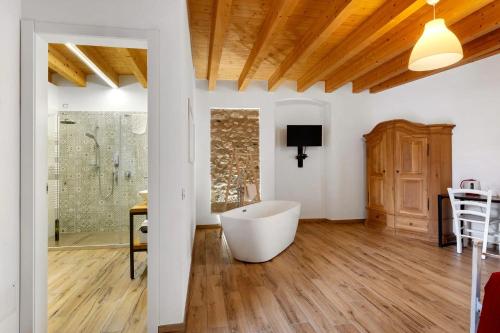 a bathroom with a tub in the middle of a room at Le Logge del Garda in San Felice del Benaco