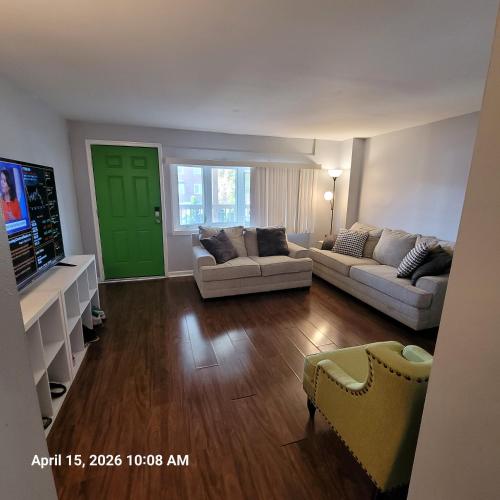 a living room with two couches and a green door at The Haven in Dundalk