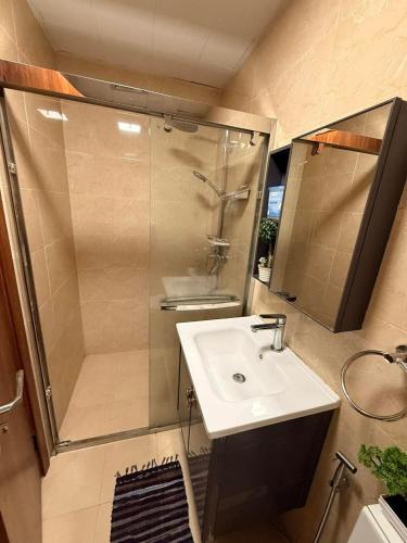 a bathroom with a shower and a sink and a shower at Bunker in Baguio