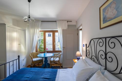 a bedroom with a bed and a table in it at Il Cortile di Mamma Mia in Pisano
