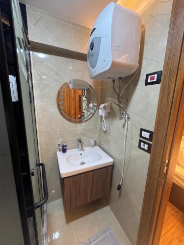 a bathroom with a sink and a camera on the wall at Montaza World inn in Alexandria