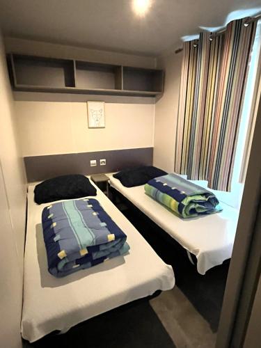 a room with two beds and a window at Luxe 6 persoons Chalet camping Leï Suves Cote d'Azur Roquebrune-sur argens in Roquebrune-sur-Argens