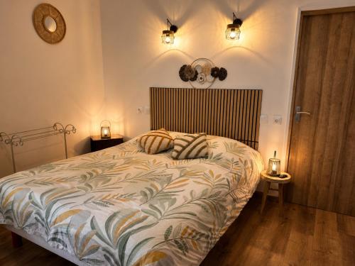 a bedroom with a bed with two pillows on it at Entre parenthèses - Grand confort et Parking privé in Le Fousseret