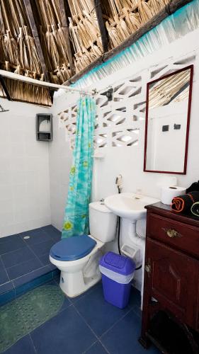 a bathroom with a toilet and a sink at Antara del Mar in San Bernardo del Viento