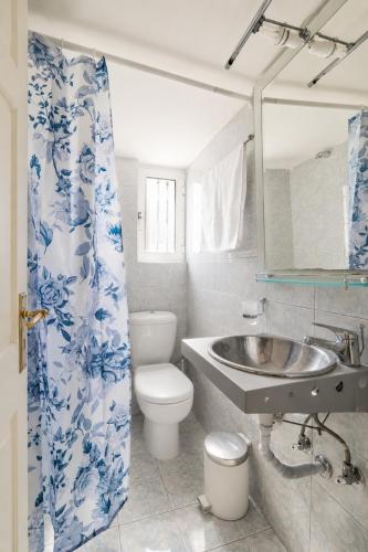 a bathroom with a sink and a toilet at Sea View Retreat in Oxílithos