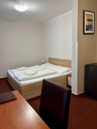 a small room with a bed and a desk at Hotel 21 in Bratislava