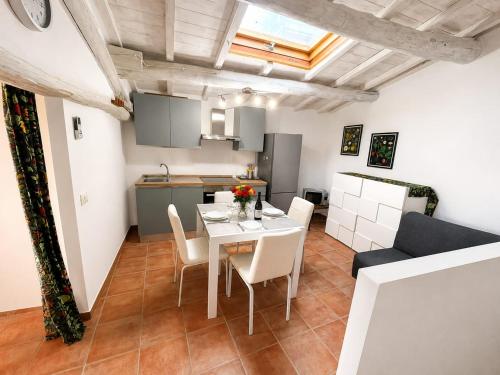 a kitchen and a dining room with a table and chairs at IN THE HILLS NEAR THE LAKE, Relax e Comfort in Grotte di Castro