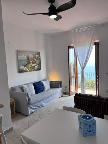 a living room with a couch and a window at Il Casalino in Maratea