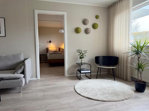 a living room with a couch and a chair at Fagraberg in Hafnarfjörður