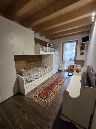 a bedroom with a bunk bed and a living room at Alpine Heaven in Borca di Cadore